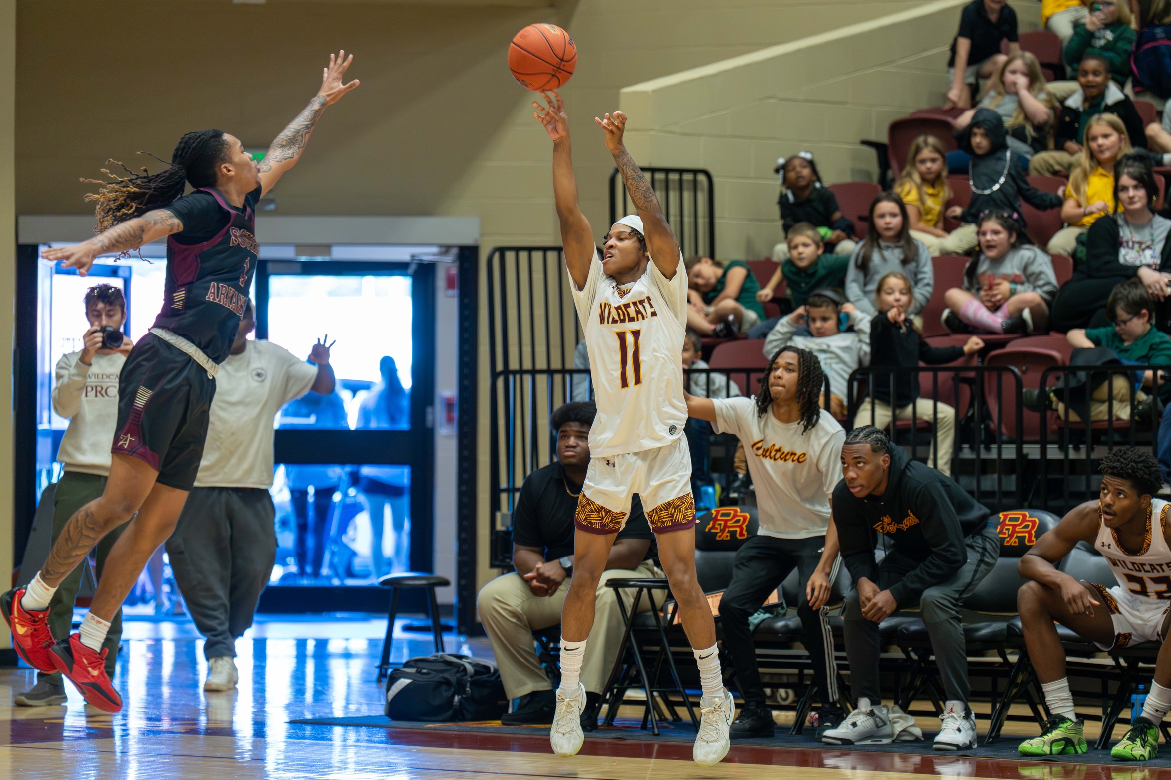 Lazarus Mason (Atlanta, Ga.; Grayson) drills a 3-pointer with a defender in his face (Karisa Watkins/PRCC Athletics).