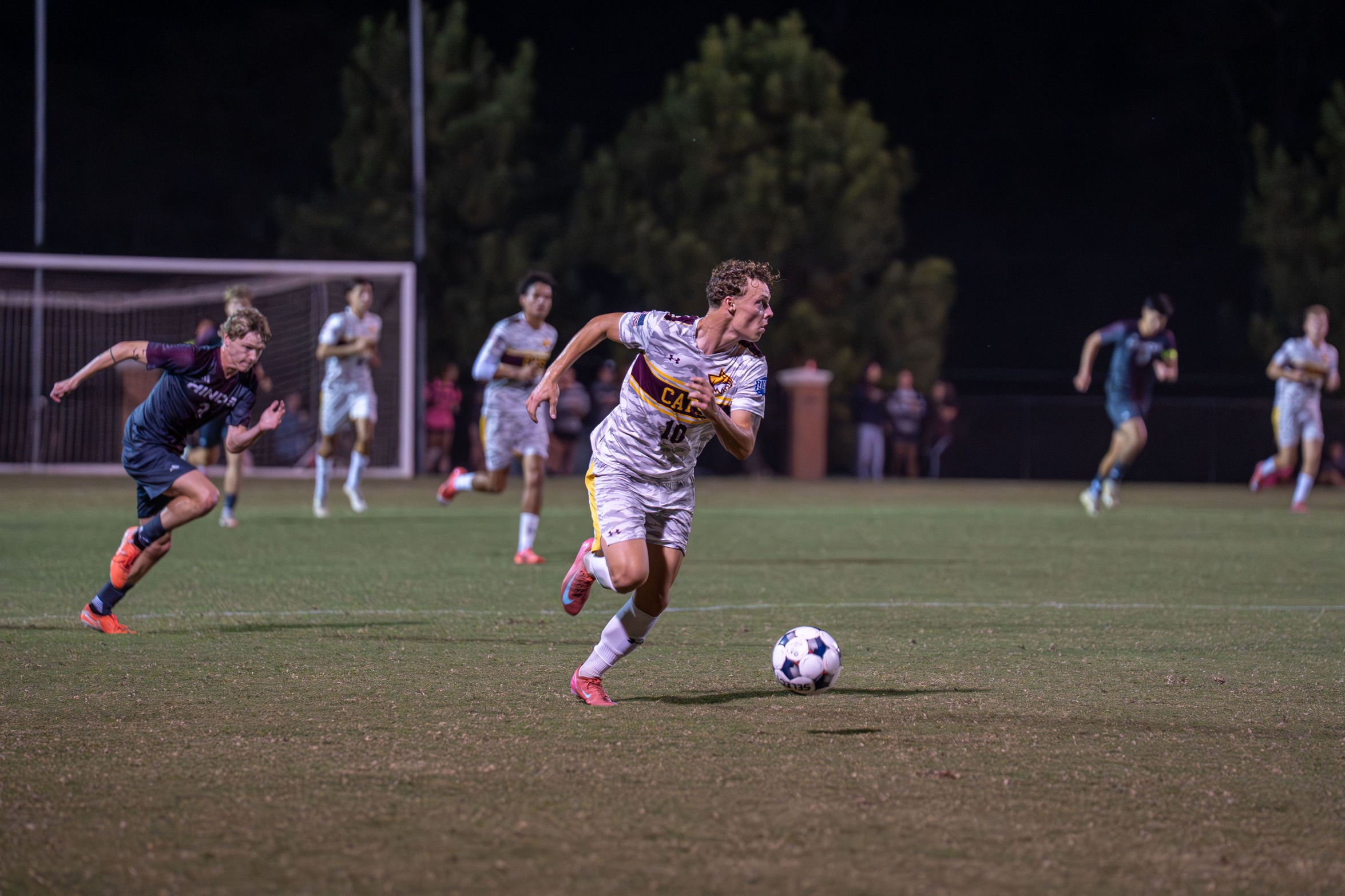 Emil Corfitzen (Copenhagen, Denmark) pushes the ball down the pitch. (Karisa Watkins/PRCCAthletics).