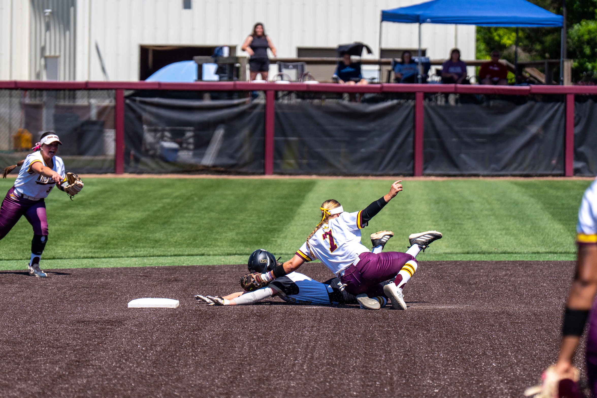 Anastasia Acree applies a tag following a throw from Taylor Foster (Grant McLeod/PRCC Athletics).
